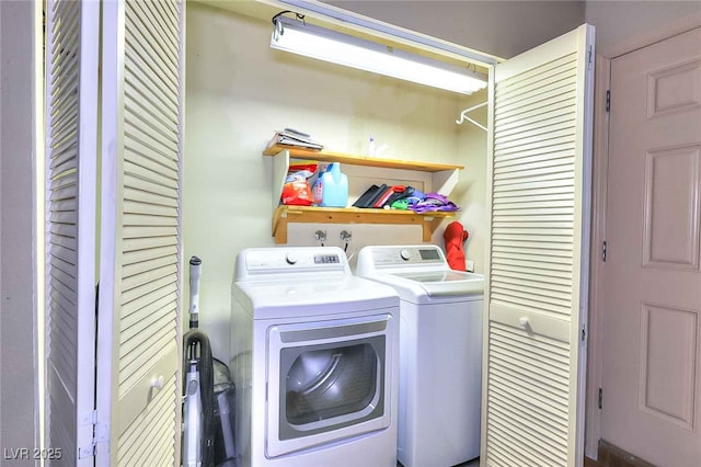 clothes washing area with washing machine and dryer