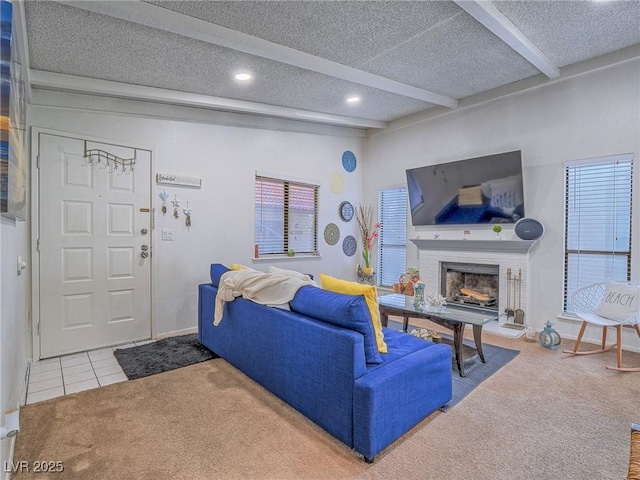 living room with beamed ceiling, a textured ceiling, and carpet