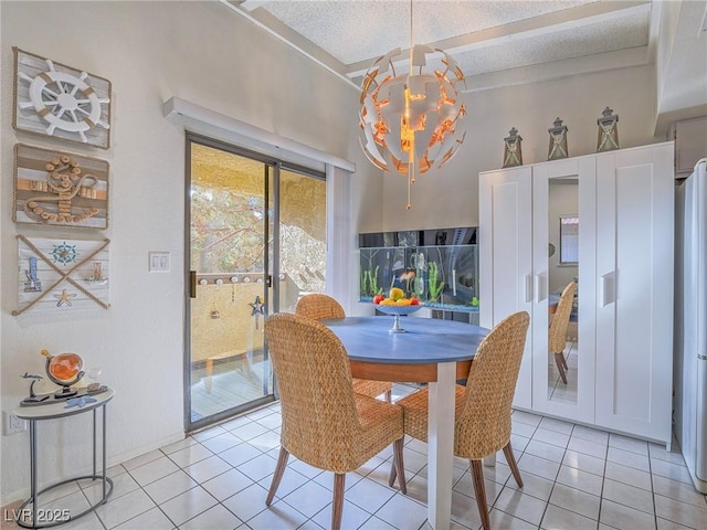 tiled dining room with a textured ceiling and a chandelier