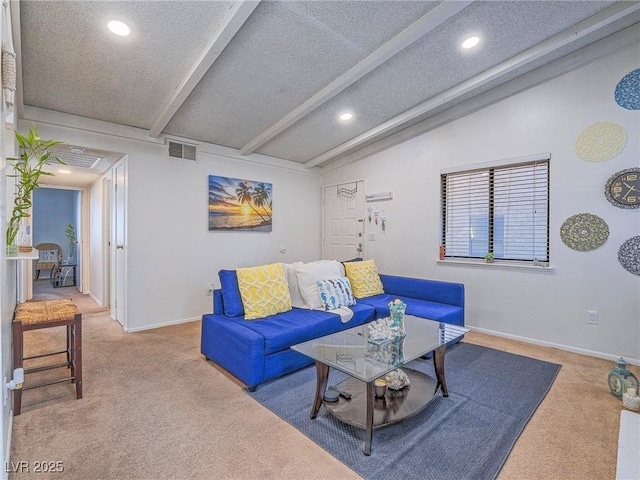 living room with lofted ceiling with beams, carpet flooring, and a textured ceiling