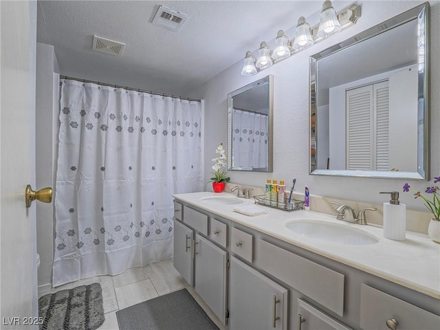 bathroom featuring vanity and a textured ceiling