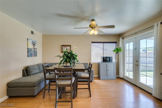 dining space featuring ceiling fan, french doors, a healthy amount of sunlight, and light wood-type flooring