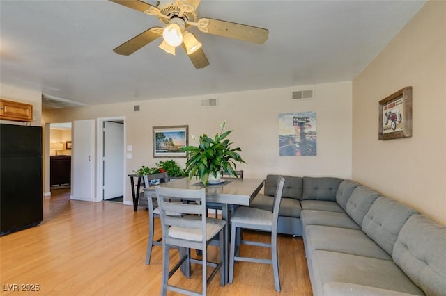 living room with ceiling fan and light wood-type flooring