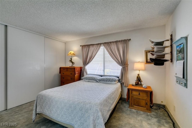 carpeted bedroom featuring a closet and a textured ceiling