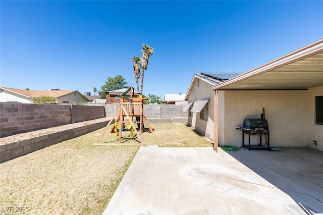 view of yard featuring a playground and a patio