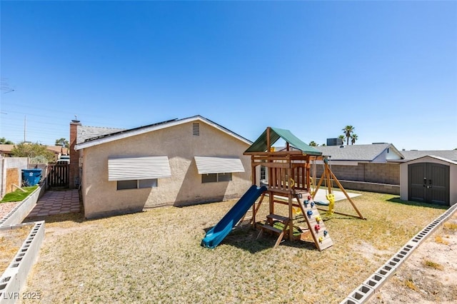 view of jungle gym featuring a storage shed