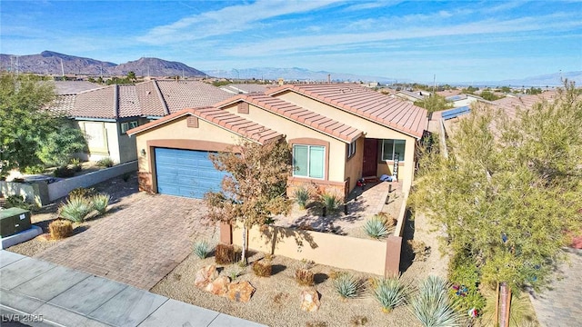 view of front of property with a mountain view and a garage