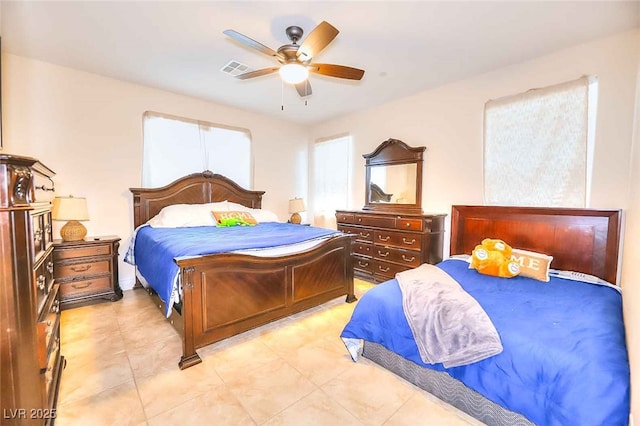 tiled bedroom featuring ceiling fan
