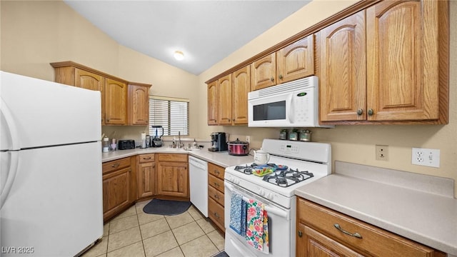 kitchen featuring vaulted ceiling, sink, light tile patterned flooring, and white appliances