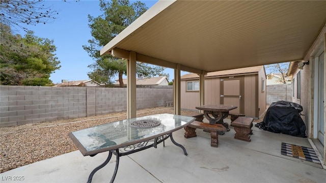 view of patio / terrace featuring a fenced backyard, an outdoor structure, and a shed