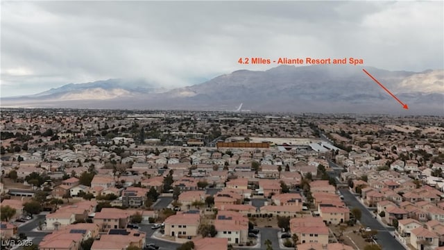 birds eye view of property with a mountain view