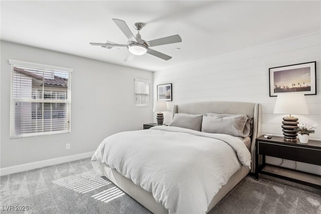 carpeted bedroom featuring multiple windows, a ceiling fan, and baseboards