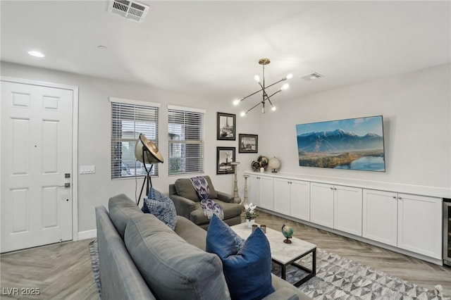 living room with recessed lighting, a notable chandelier, baseboards, and visible vents