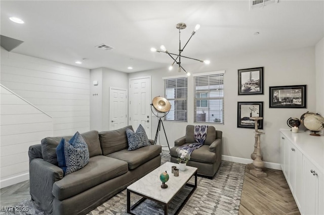 living area with visible vents, wooden walls, baseboards, recessed lighting, and light wood-style floors