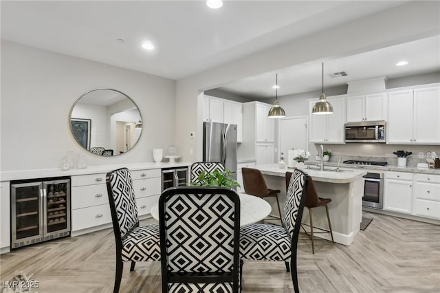 dining room with recessed lighting, visible vents, and wine cooler