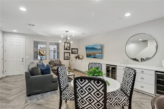 dining area with wine cooler, visible vents, recessed lighting, and a chandelier