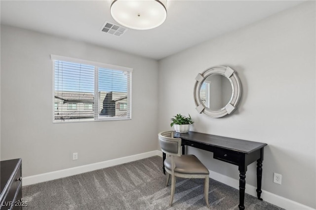 carpeted office space featuring baseboards and visible vents