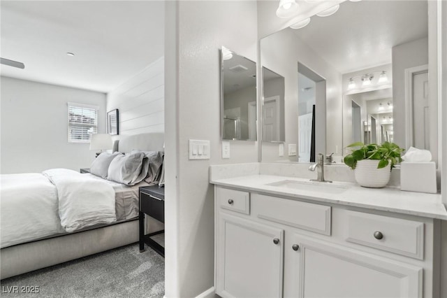 ensuite bathroom featuring vanity and connected bathroom