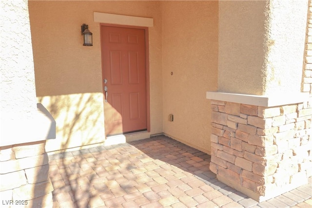 doorway to property with a patio area