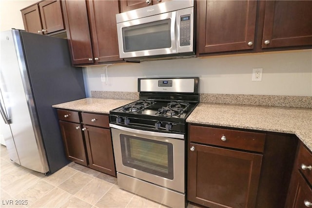 kitchen featuring dark brown cabinets and stainless steel appliances