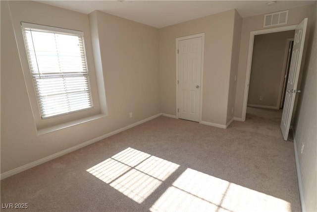 unfurnished bedroom featuring light colored carpet