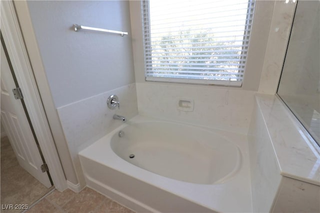 bathroom featuring a bath and tile patterned flooring