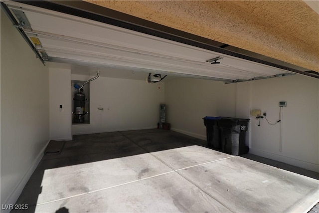 garage with a garage door opener and water heater