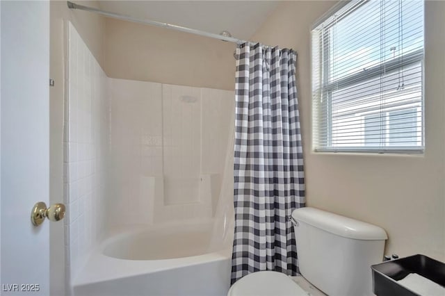 bathroom with shower / bath combination with curtain and toilet