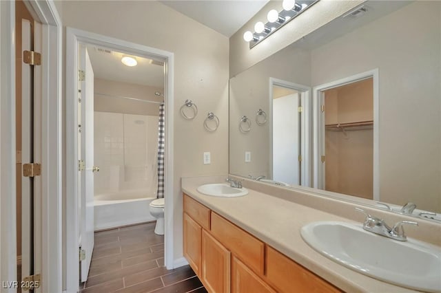 full bathroom with shower / bath combination with curtain, vanity, and toilet