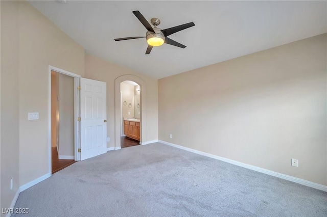 unfurnished bedroom featuring ceiling fan, carpet, and ensuite bath