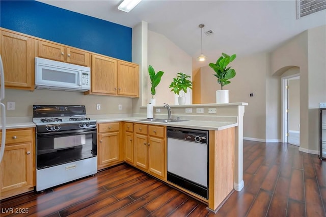 kitchen with sink, white appliances, dark wood-type flooring, decorative light fixtures, and kitchen peninsula