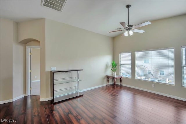 unfurnished room featuring lofted ceiling, dark hardwood / wood-style floors, and ceiling fan