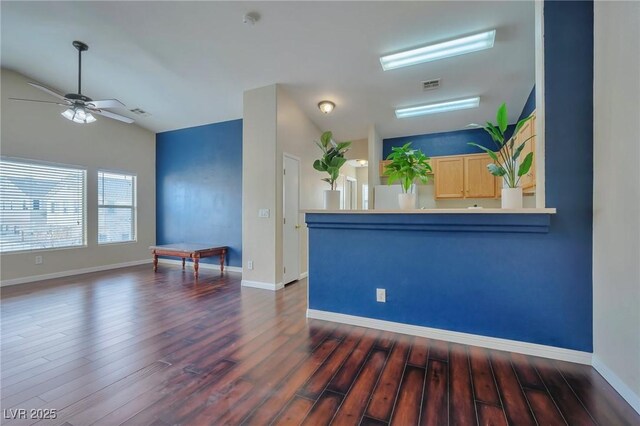 interior space with light brown cabinetry, vaulted ceiling, dark hardwood / wood-style flooring, white fridge, and ceiling fan