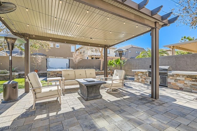 view of patio / terrace with fence private yard, an outdoor hangout area, an outdoor kitchen, and area for grilling