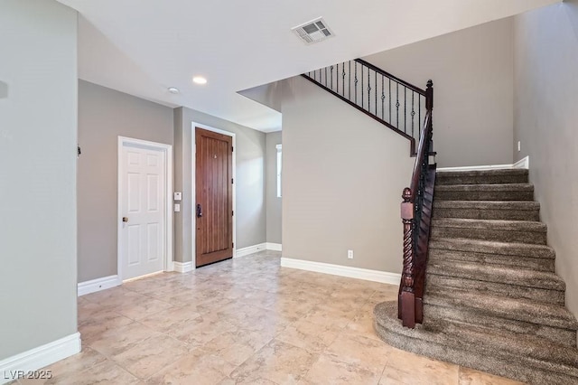 entryway featuring visible vents, baseboards, and stairs