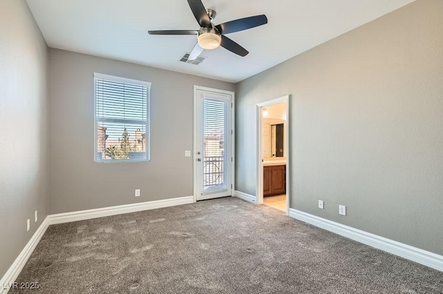 unfurnished room featuring a ceiling fan, light colored carpet, visible vents, and baseboards