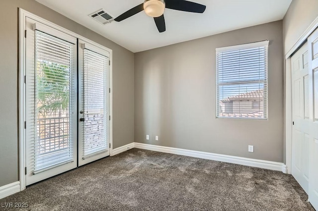 unfurnished room with baseboards, visible vents, a ceiling fan, carpet flooring, and french doors