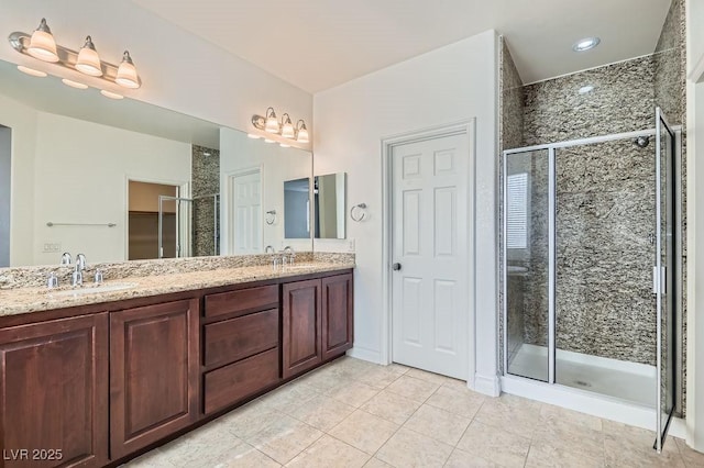 full bathroom featuring tile patterned floors, a sink, a shower stall, and double vanity