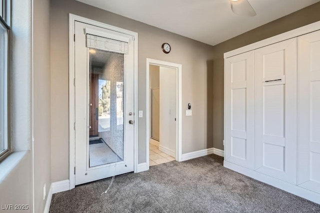 interior space featuring carpet floors and baseboards