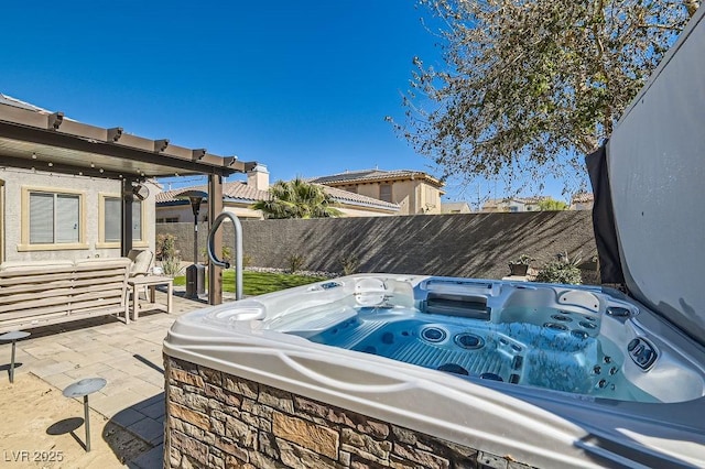 view of patio featuring a fenced backyard and a hot tub