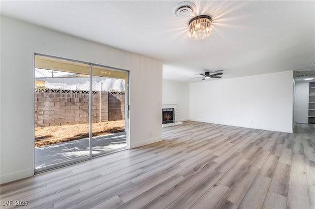 unfurnished living room with ceiling fan and light hardwood / wood-style floors