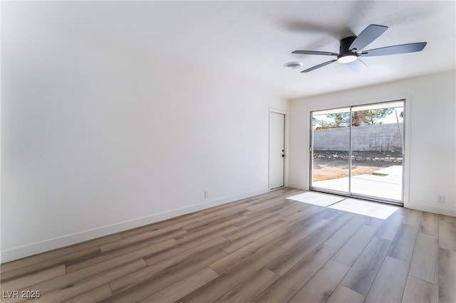 spare room featuring ceiling fan and light wood-type flooring