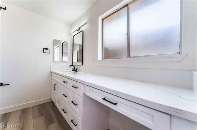 bathroom featuring hardwood / wood-style flooring, vanity, and plenty of natural light