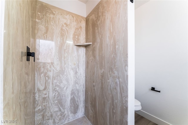 bathroom featuring walk in shower and toilet