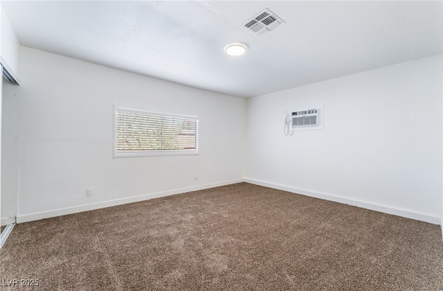 empty room featuring a wall mounted AC and carpet floors