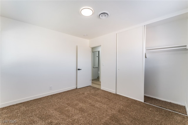 unfurnished bedroom with a closet and carpet