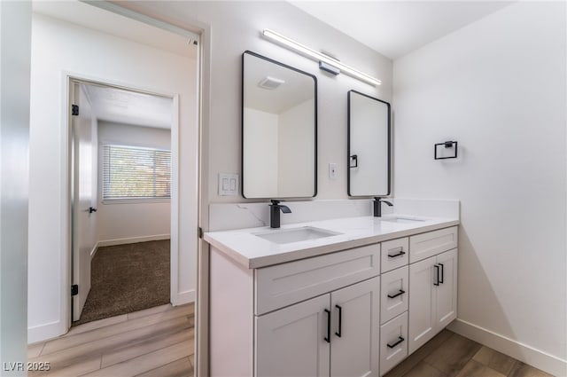 bathroom featuring vanity and hardwood / wood-style floors