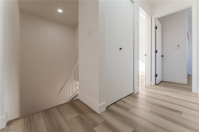 corridor with light hardwood / wood-style floors