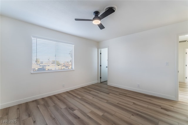 empty room featuring ceiling fan and light hardwood / wood-style flooring