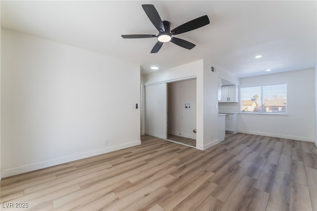 unfurnished living room with ceiling fan and light hardwood / wood-style floors